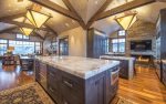 Spacious kitchen with marble counter-tops, state of the art appliances, and fireplace.
